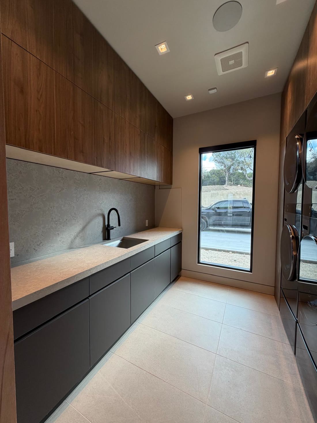 The laundry run in walnut over graphite with a stone counter