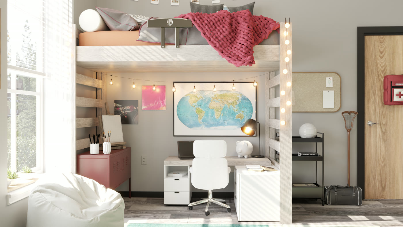The desk under the loft bed, with a world map pinned above it