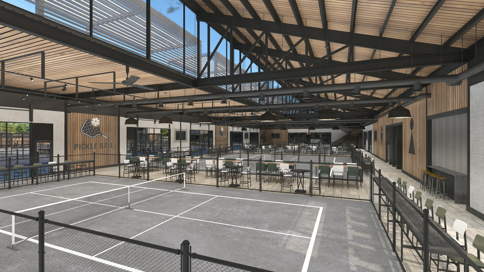 The indoor hall from the entrance, courts to the left and the seating rail to the right