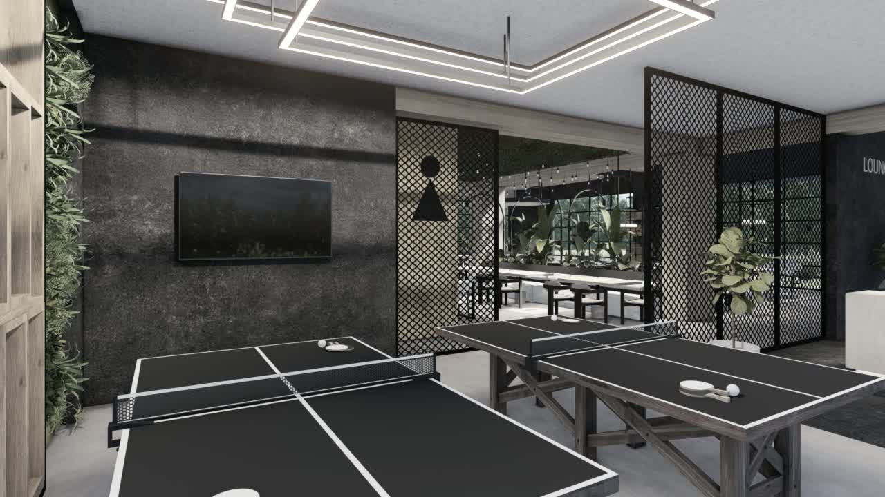 The games room: a ping pong table behind a mesh screen, a screen on the wall