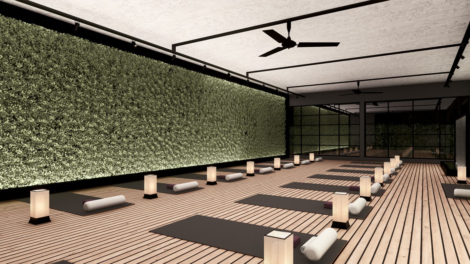 The yoga studio: a timber floor with mats, bolsters and paper lanterns, a living wall on one side and black-framed glazing on the other