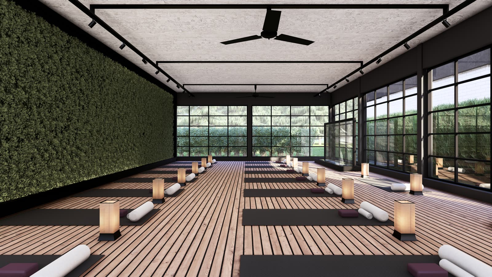 The yoga studio: a timber floor with mats, bolsters and paper lanterns, a living wall on one side and black-framed glazing on the other
