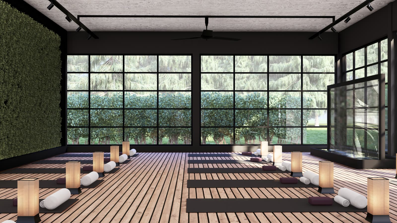 The yoga studio: a timber floor with mats, bolsters and paper lanterns, a living wall on one side and black-framed glazing on the other