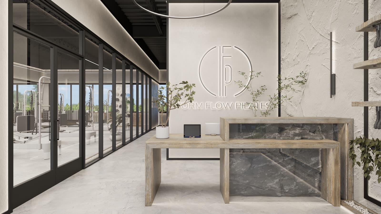 Form Flow Pilates, the front desk in pale timber and stone with the reformer studio behind a glass wall