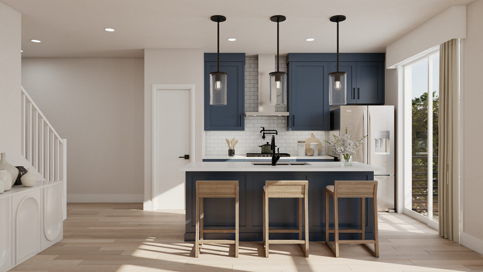 Lots 11 to 16, an apartment kitchen in navy cabinetry with an island and open stair