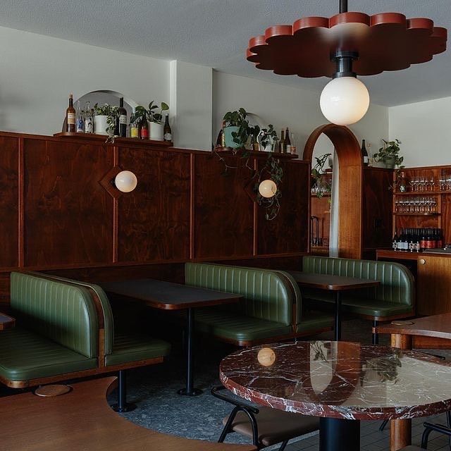 Cafe or restaurant, Oxblood booths, red pleated pendant, green upholstery, deco