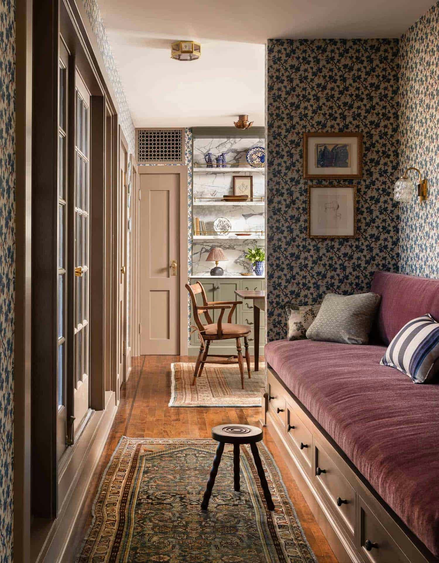 Living room, Burgundy banquette, patterned rug, moody