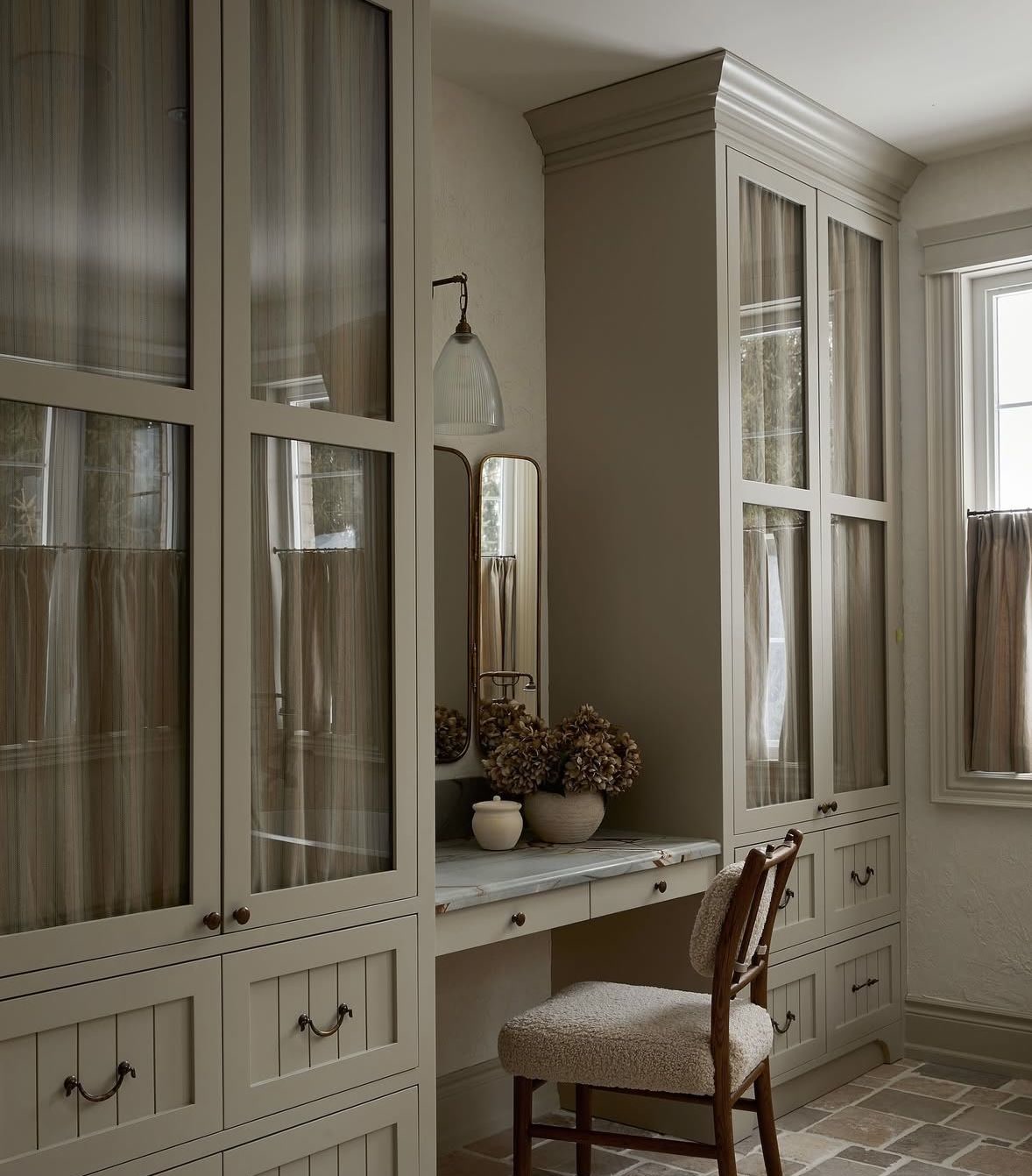 Office or studio, Glazed cream cabinets, desk, brick floor, classic