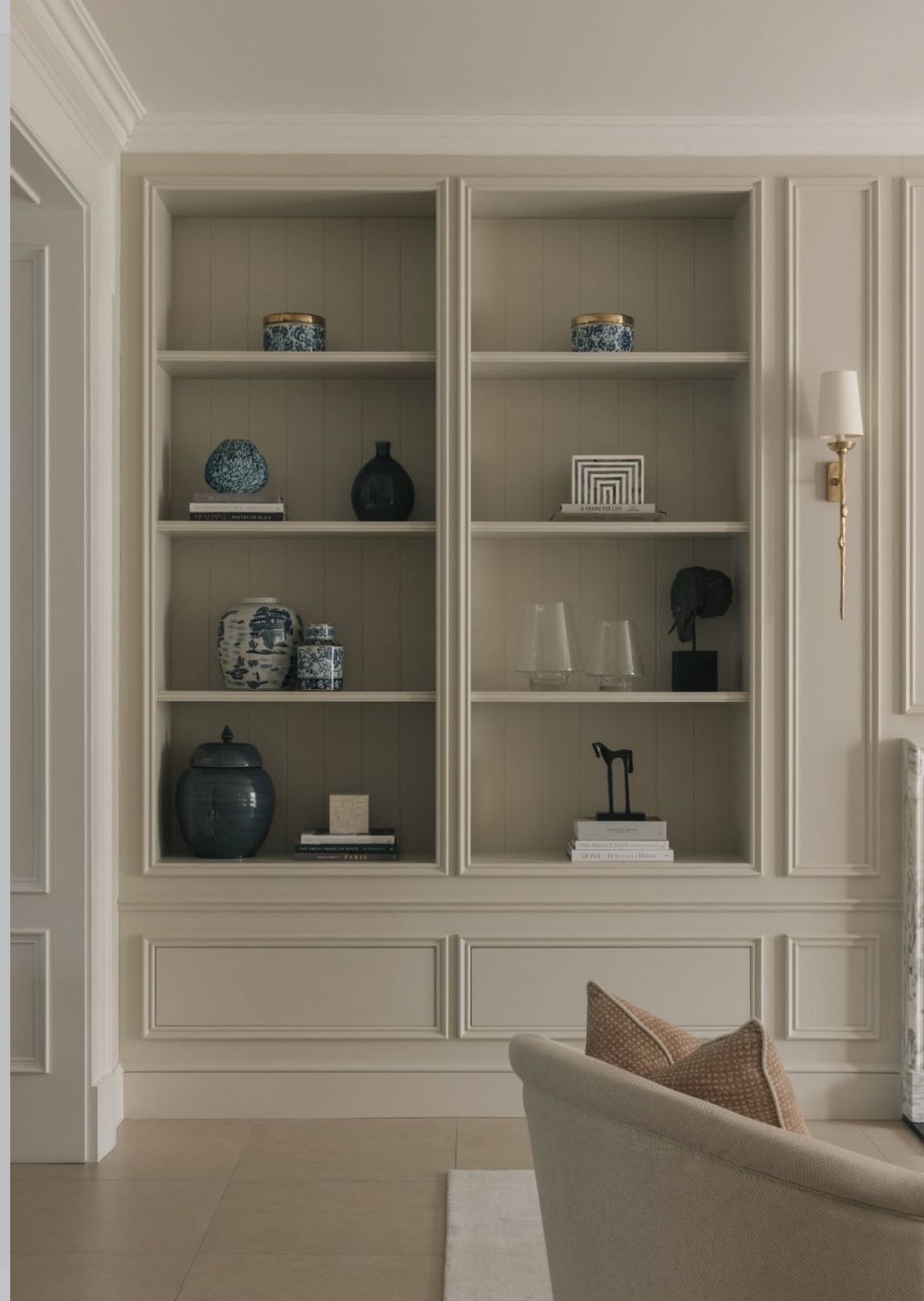 Office or studio, Cream shelving niche, blue ceramics, classic