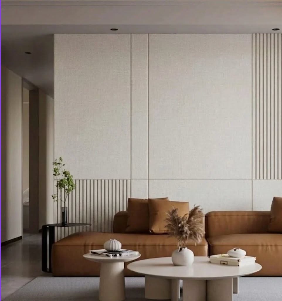 Living room, Fluted cream wall, tan sofa, round tables, modern