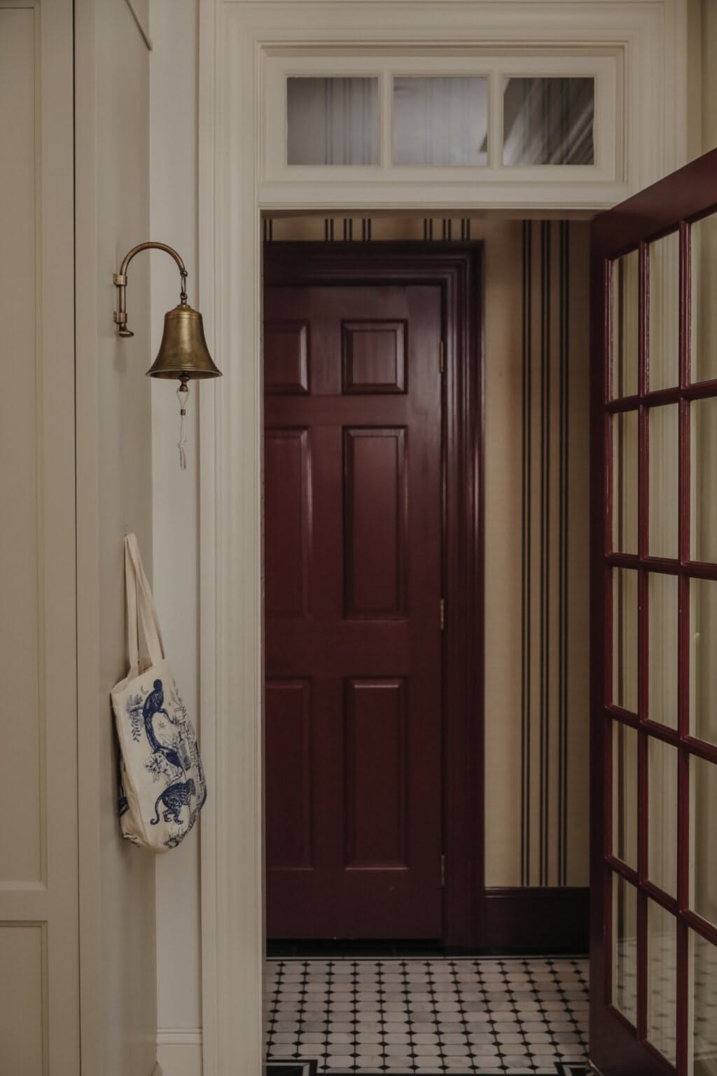 Foyer or stair, Cream hall, burgundy door, tile floor, classic