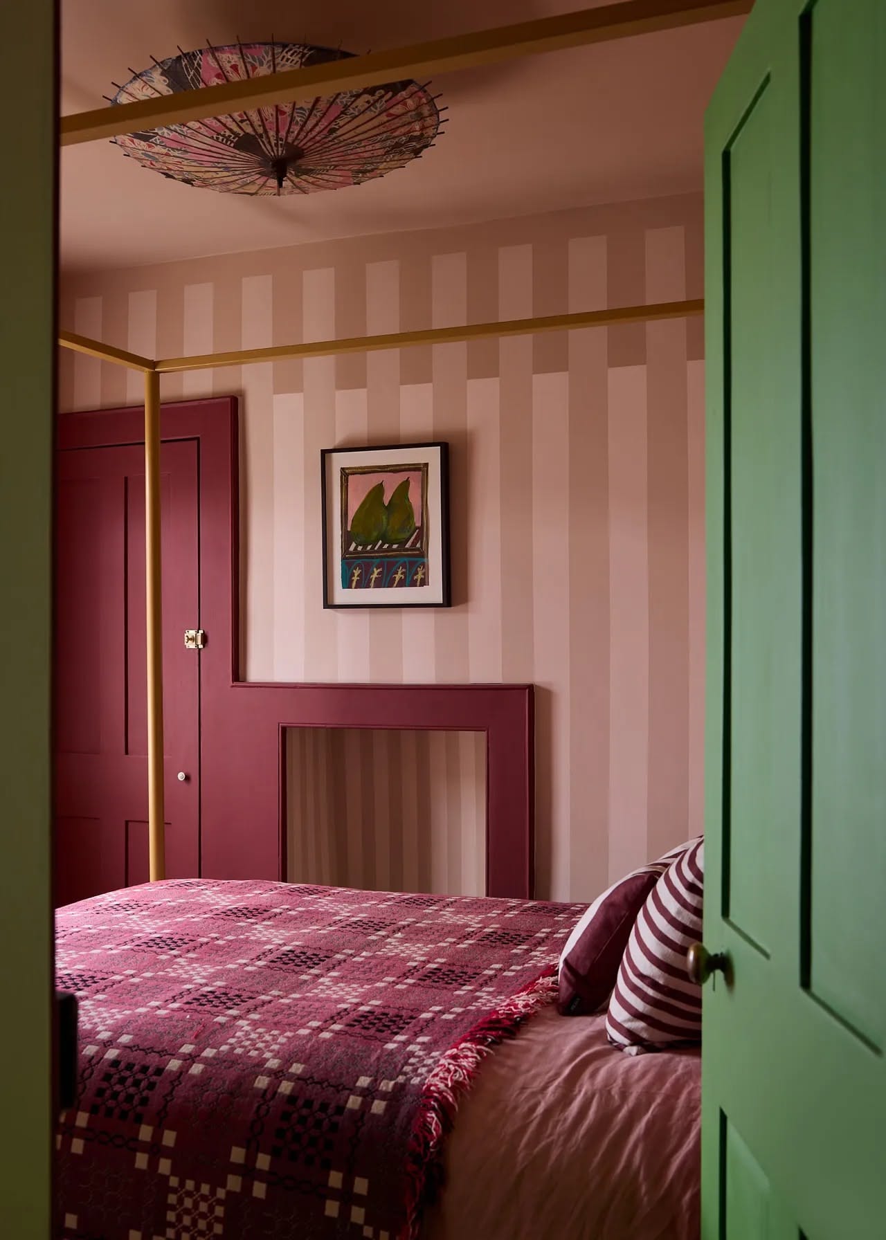 Bedroom, Pink striped walls, green door, patterned bed, playful