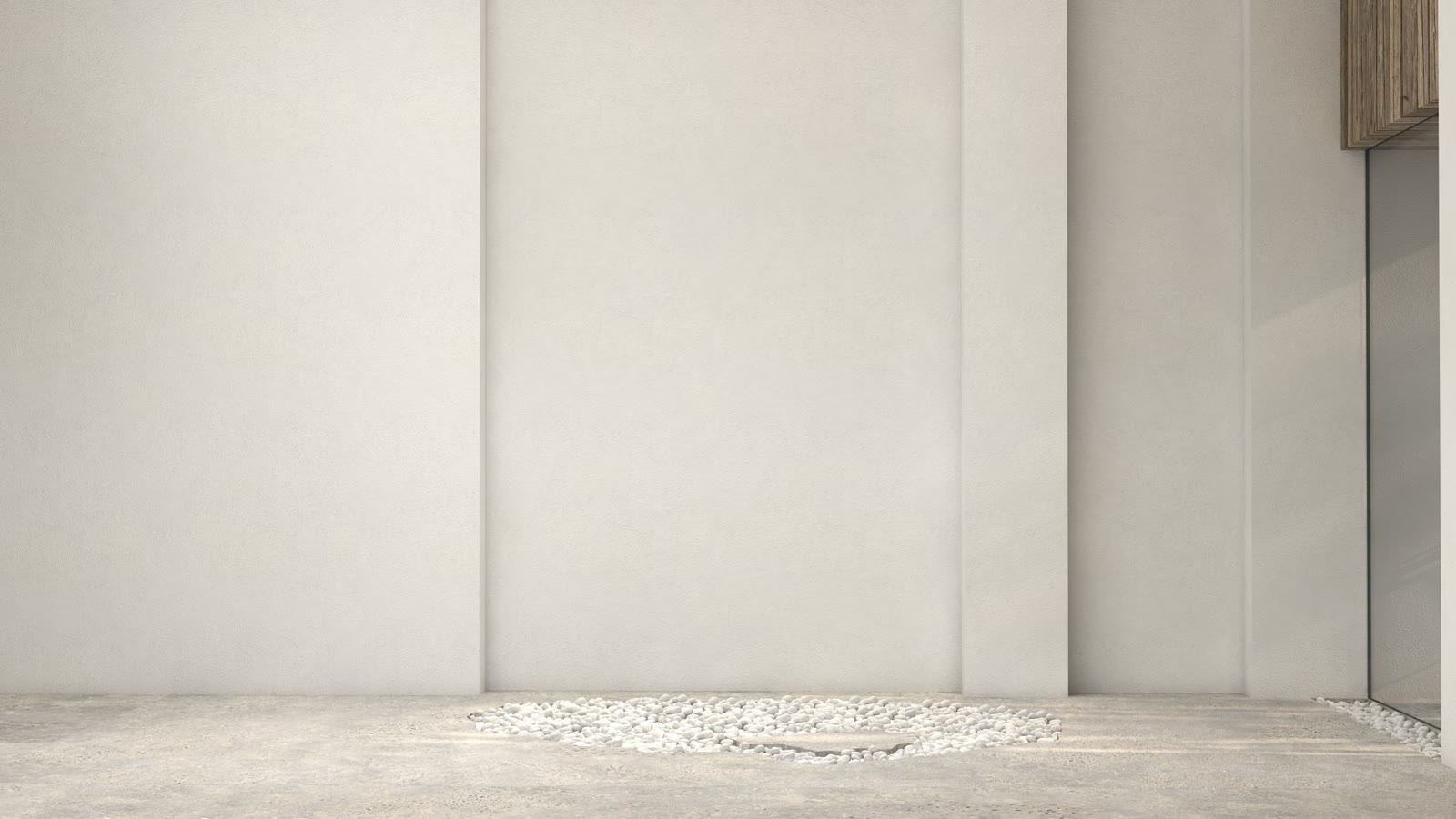 Bare plaster wall and a gravel bed, nothing installed