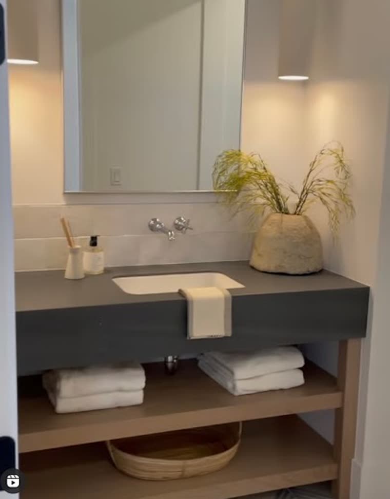 Reference screenshot: a stone vanity with sconces and timber